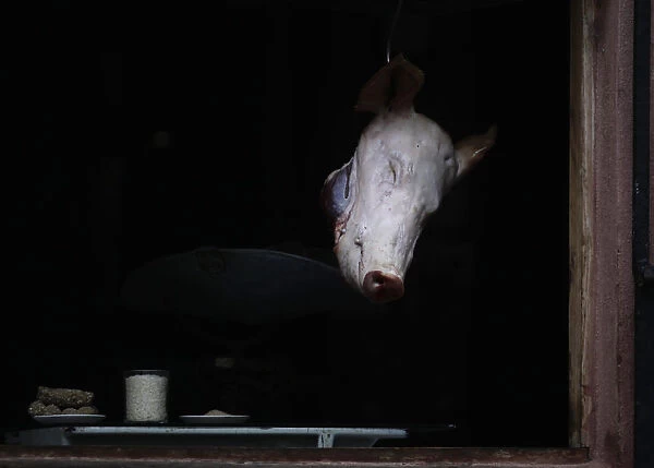 A pigs head is displayed for sale at a butcher stall in Havana