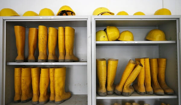 Rubber boots and helmets are stored for visitors at the construction site of the new