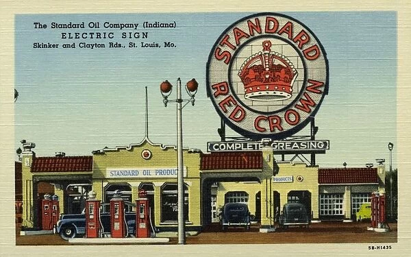 Standard Oil Gas Station. ca. 1945, St. Louis, Missouri, USA, The Standard Oil Company (Indiana) ELECTRIC SIGN Shrinker and Clayton Rds. St. Louis, Mo. STANDARD OILs HUGE ELECTRIC SIGN AND ITS DEALERs SERVICE STATION consume about the same amount of current as an average town of 1000 people. Sign is 40 ft. in diameter and 70 ft. to the top. It required 44 tons of steel and 7 1  /  2 tons of sheet metal. Has 5600 lamps and 2900 ft. of neon tubing with 87 electrical circuits and 5 miles of wire