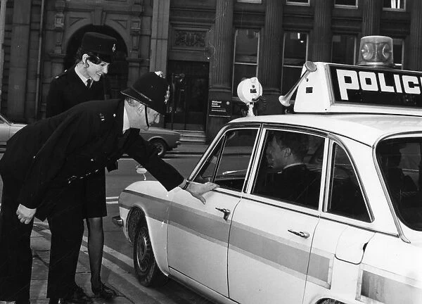 Policeman and policewoman with police car, Sheffield, 1972