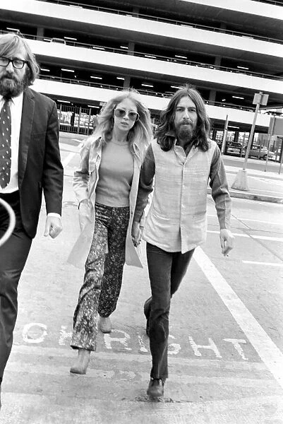 George Harrison of the Beatles with his wife Pattie at Heathrow today after seeing offhis