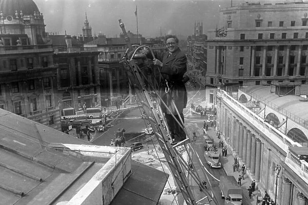 Herbert Morrison, Minister of Home Security, up a ladder, London. 1942