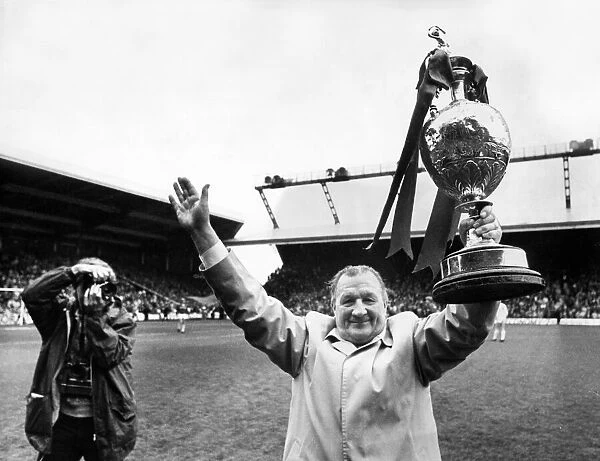 Liverpool manager Bob Paisley celebrates with the League Championship trophy at Anfield