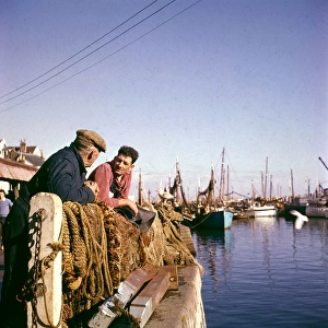 Two fishermen in Brixham Harbour, Devon