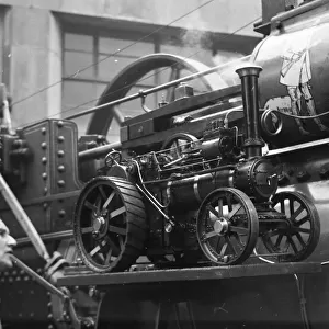 Traction engine model on running board of a full size engine