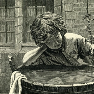 Young boy at a wash tub