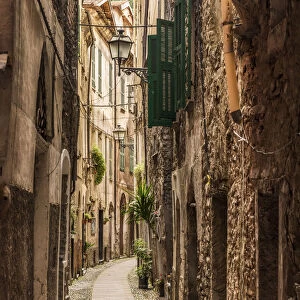Europe, Italy, Liguria. Badalucco. One of the narrow streets of the little town
