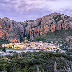 Scenic view of the village with the Mallos de Aguero rock formations behind, Aguero, Huesca, Aragon, Spain