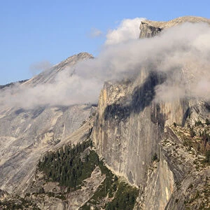Half Dome partially covered in cloud view from Glacier Point