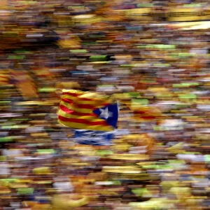 A pro-independence supporter waves a Catalan separatist flag, known as Estelada