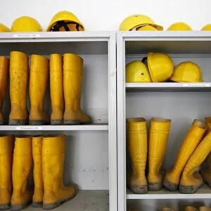 Rubber boots and helmets are stored for visitors at the construction site of the new