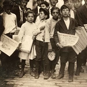 NEW YORK: NEWSBOYS, 1910. A group of newboys and one newsgirl getting the afternoon