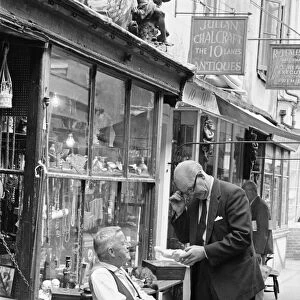 An antique dealers talking to a customer outside his shop in The Lanes in Brighton
