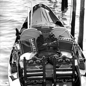 General scenes in Venice. A gondolier catches a quick forty winks between fares