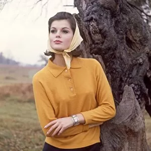 Female model in mustard polo sweater and headscarf